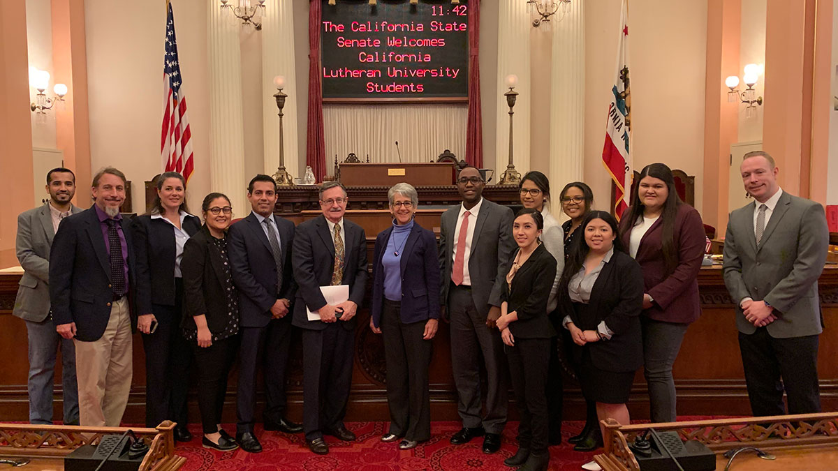 Sacramento Institute course students and Professor Herb Gooch receiving a warm welcome on the State Senate Floor.