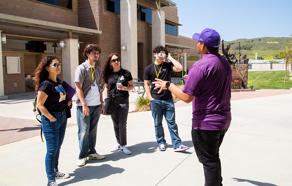 Presidential Host giving a tour to a group of students and family members