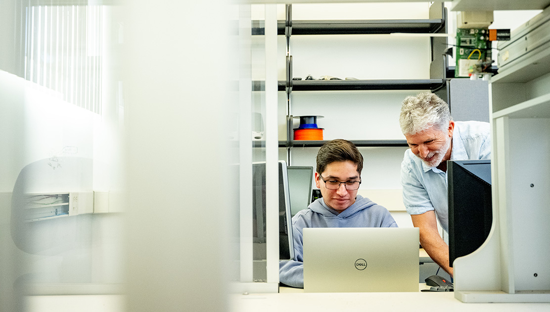 Faculty member helping student